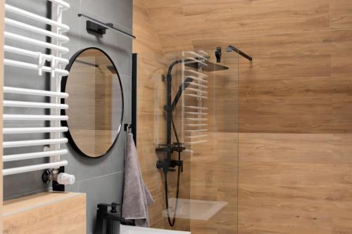 a bathroom with a shower and a mirror at Słoneczna 49 in Miedziana Góra