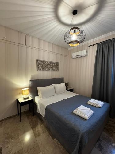 ein Schlafzimmer mit einem großen Bett und einer Deckenleuchte in der Unterkunft Arkadins in Zakynthos
