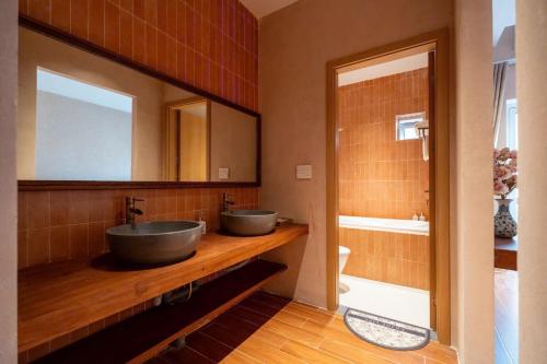 a bathroom with two sinks and a mirror at QUEEN VILLA - Hoa Tiên paradise in Ðông Hội