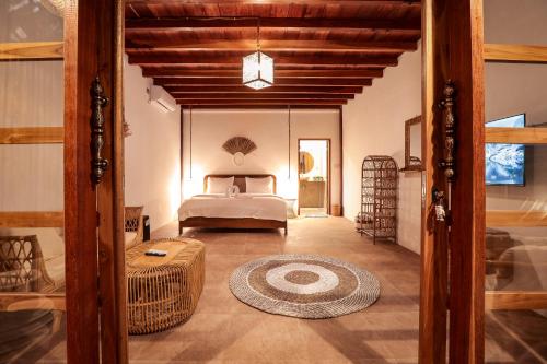 a large bedroom with a bed and a room with at The Lost Island- Luxury Private Pool Villas in Gili Trawangan