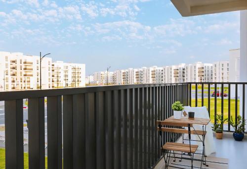 a balcony with a table and a view of buildings at The Pearl Nest Spacious 2BHK in Madinatna Better Than a Hotel, Halff the Price in Doha