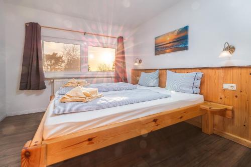a bedroom with a large wooden bed in a room at Heimathafen in Thiessow