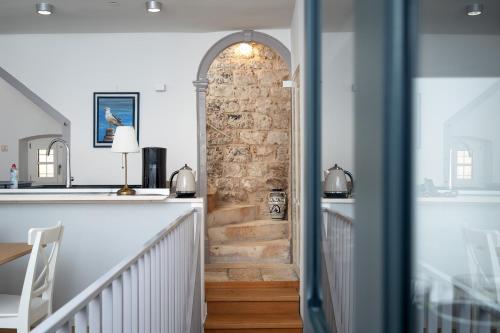 a staircase in a home with a brick wall at Villa Dida Hvar in Hvar