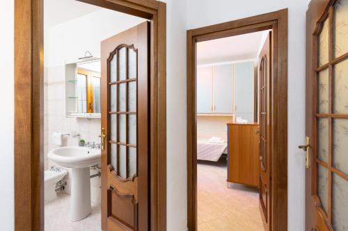 a bathroom with a sink and a toilet at Tavolara Ichnos House in San Teodoro