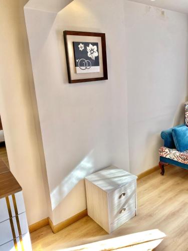 a living room with a table and a blue chair at 18B Shehb Apartment Hotel in Giza