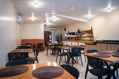 a restaurant with tables and chairs in a room at Porto Seguro Hotel - Porto Velho in Porto Velho
