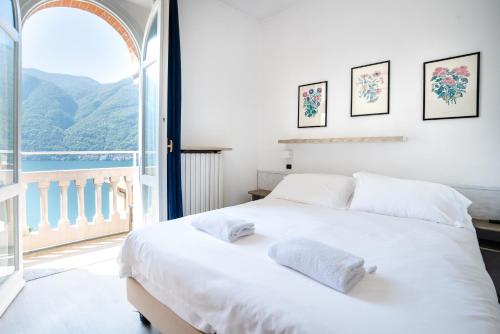 a bedroom with a white bed and a large window at Briisa De Ness in Nesso