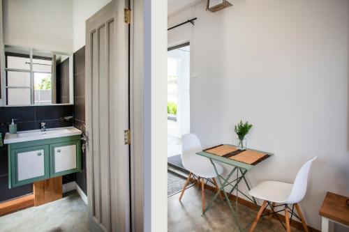 a kitchen and a dining room with a table and chairs at Le Morne Base - Stylish, Pool & Rooftop in La Gaulette