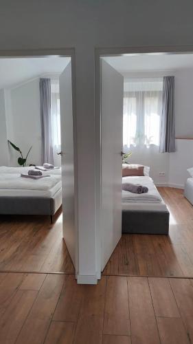 two beds in a room with a mirror at Apartament DobraNocka in Ściegny