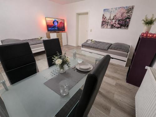 a living room with a table and chairs and a couch at Mitarbeiterwohnung nahe Saaleck Kaserne in Hammelburg