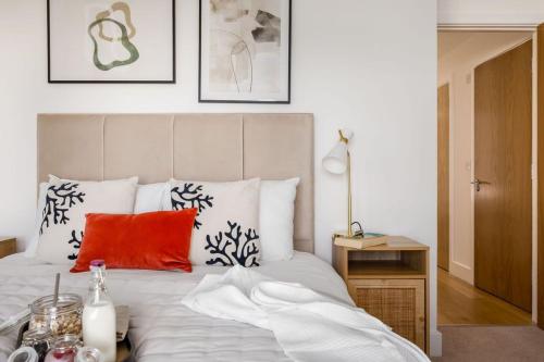 a bedroom with a white bed with a red pillow at Jurassic in Dorchester