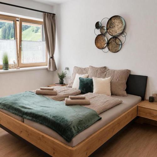 a bedroom with a large bed with at Boutique Appartements Kumming inkl Nationalparkcard in Rauris