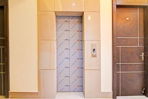 a closet with a door with diagrams on it at Super Hotel O SAMOTEL in kolkata