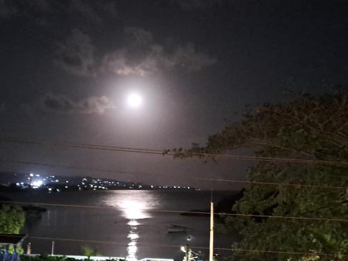 a moonlight over a body of water at night at By The Bay 2plus2 in Oracabessa
