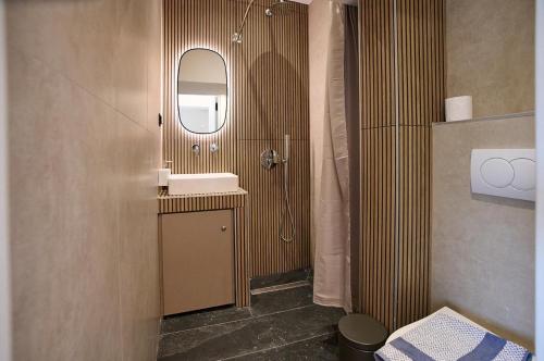a bathroom with a sink and a mirror at Iraklia Coral in Nea Irakleia