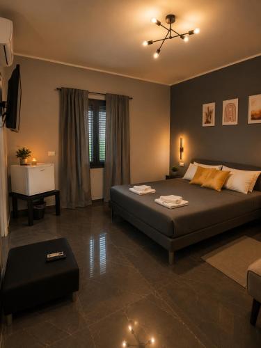 a bedroom with a large bed and a table at Reale Mountain View in Mascalucia