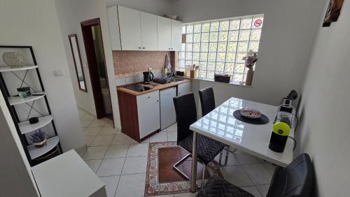 a kitchen with a table and some chairs in a room at Apartment Tara in Igalo