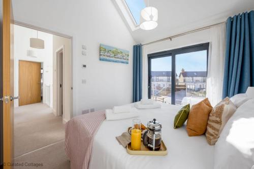 a bedroom with a large white bed with a window at Dawn Lighthouse in Dorchester