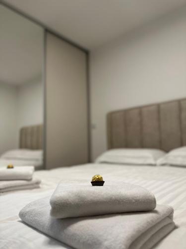 a pile of towels sitting on top of a bed at Golden Nest in Tuzla