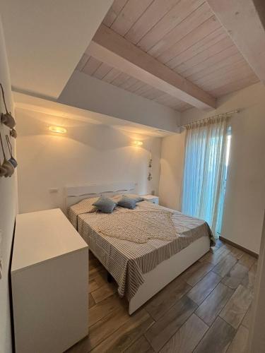 a bedroom with a bed with blue pillows on it at Residence Fortuna - Appartamento Gori in Fano