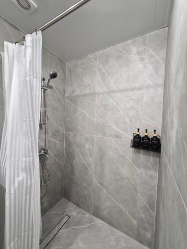 a bathroom with a shower with a shower curtain at Noosh Ashnak guesthouse in Ashnak