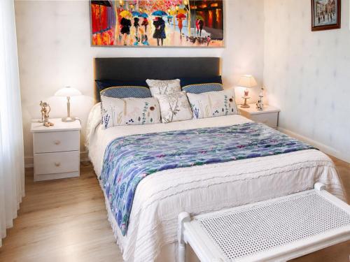 a bedroom with a large bed and two night stands at Villa Marguerite in Coutras