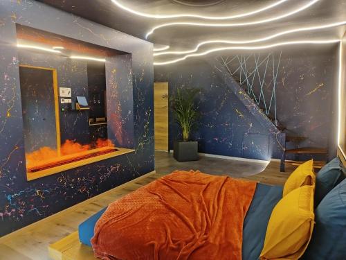 a room with a bed and a wall with a universe at Love Room avec Jacuzzi Privatif Loft Sensation Romantique in Renwez