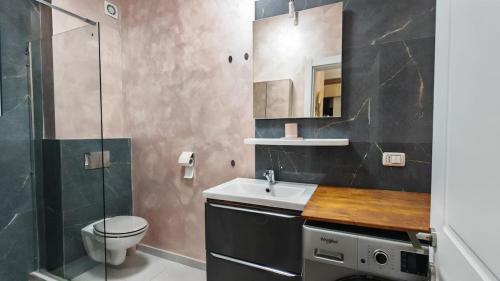 a bathroom with a sink and a toilet and a shower at Onix Home Love 203 in Mamaia Sat/Năvodari