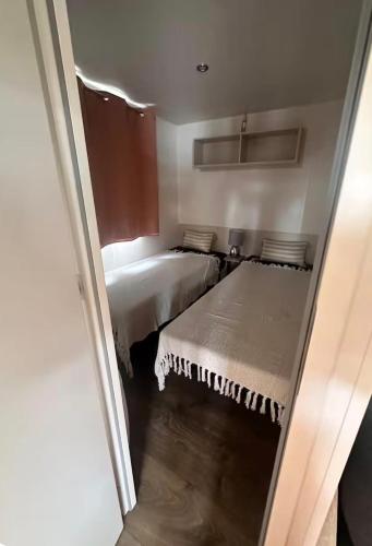 a small room with two beds in a room at Le Cocon d'Ambon in Ambon