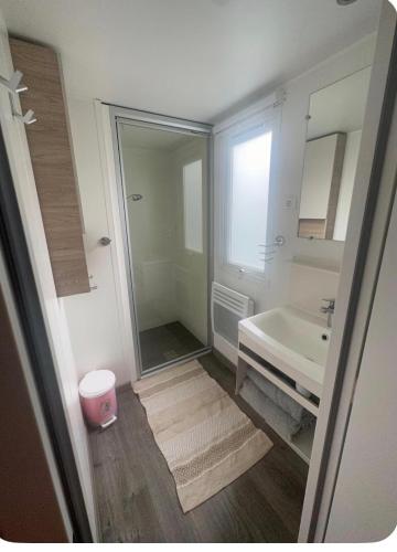 a bathroom with a sink and a tub and a mirror at Le Cocon d'Ambon in Ambon