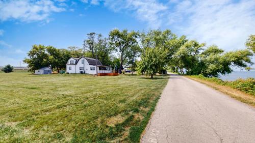 a house on a field next to a road at The Majestic Oasis in Vineland Station