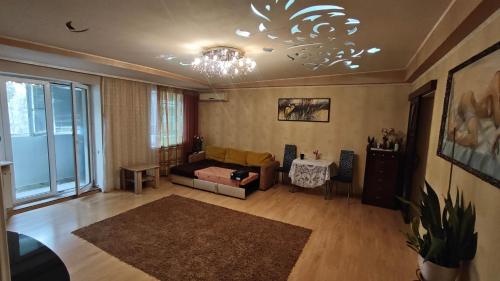 a living room with a couch and a chandelier at Spacious apartment on Otakar Yarosh in Kharkiv