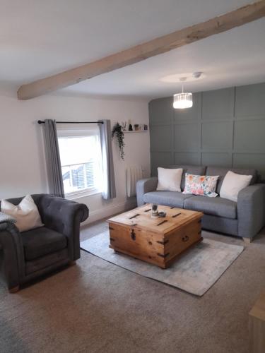 a living room with two couches and a coffee table at Ironbridge town apartment in Ironbridge