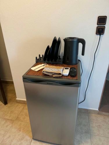 a counter with a coffee pot on top of a refrigerator at ZOGRAFOS 2 in Haraki