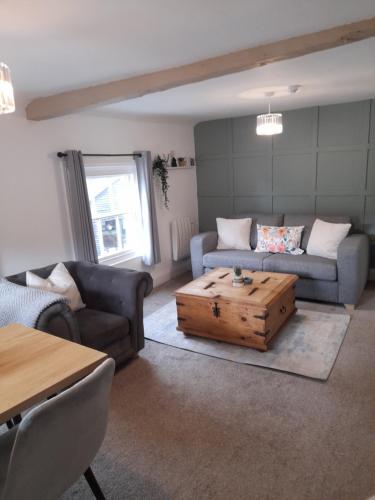 a living room with a couch and a coffee table at Ironbridge town apartment in Ironbridge