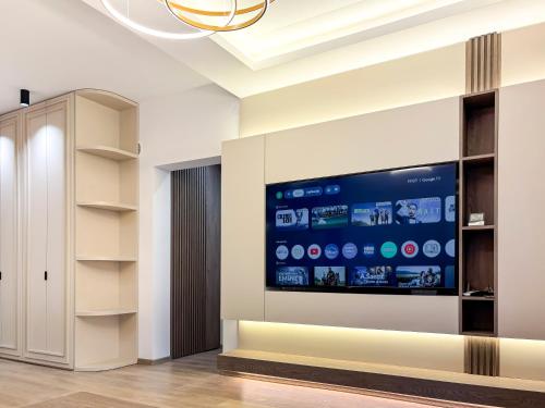 a living room with a large flat screen tv on the wall at SKY Apartment in Sarajevo