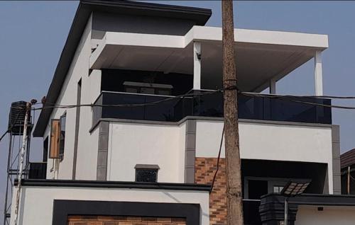 a large white building with a lot of windows at OYO Serviced Apartment in Egbe