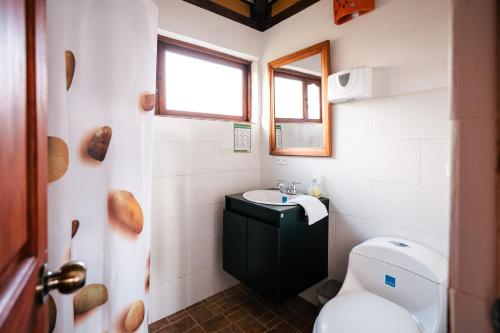 a small bathroom with a toilet and a sink at Cabañas Sol y Luna in Villa de Leyva