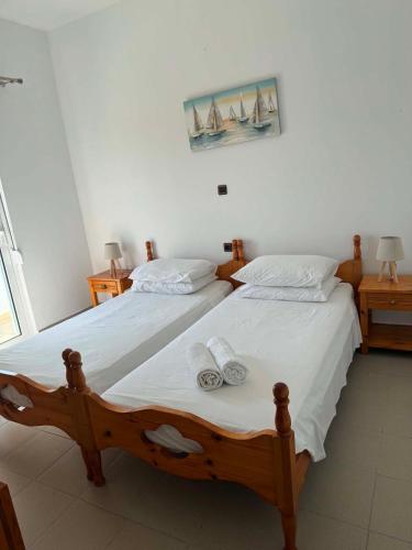 a bedroom with two beds with towels on them at ZOGRAFOS 1 in Haraki