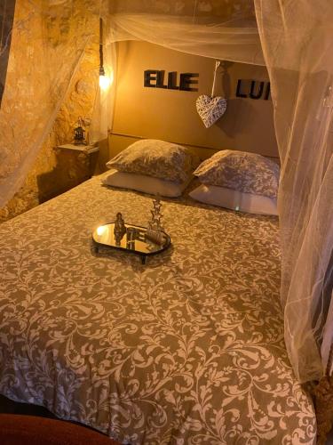 a bedroom with a bed with a tray on it at L'écrin de Najatte in Bourg-sur-Gironde