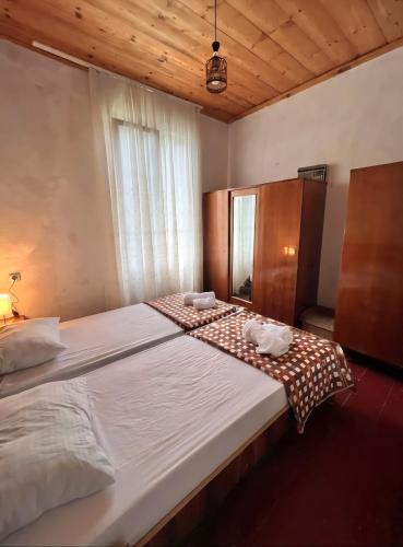 a bedroom with a large bed with two towels on it at Utsera Veranda in Utsera