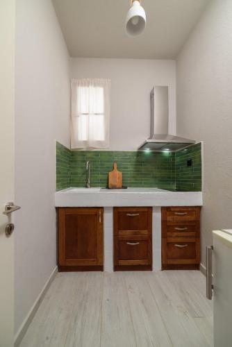 a kitchen with a sink and a counter top at Archontiko Seaside Hotel-Beachfront Blue Experience in Platanias