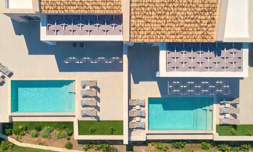 an aerial view of a building with two swimming pools at Marea Villas Heated Pool in Dhrámia