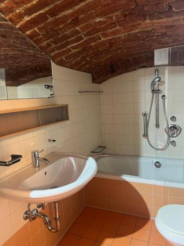 a bathroom with a tub and a sink at Bei Poldi in Paldau