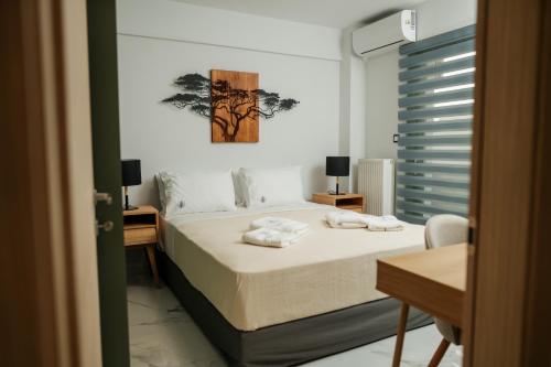 a bedroom with a bed with two towels on it at Karnayo II in Keramoti