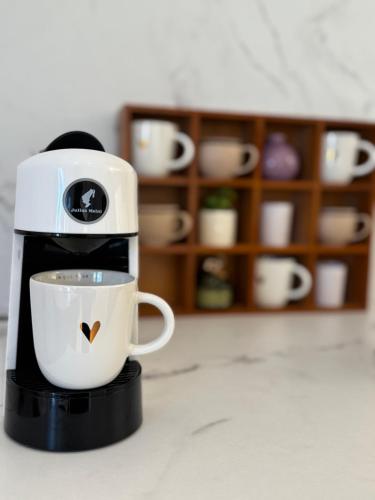 a coffee maker is holding a cup on a counter at Modern Design Apartment Salona I Stylish & Comfortable Solin I Split in Solin