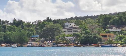 a large house on the shore of a body of water at By The Bay 2plus2 in Oracabessa