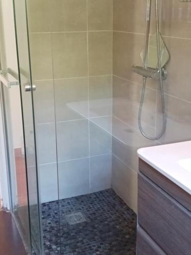 a bathroom with a shower with a glass door at La Villa des Restanques in Carry-le-Rouet