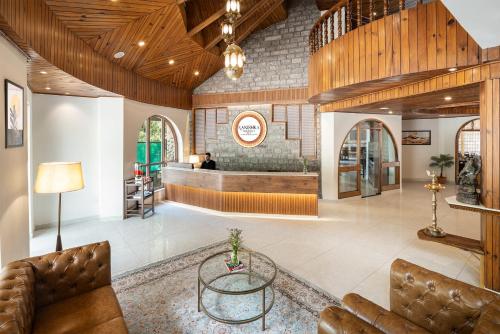 a lobby with a waiting room and a table at Kanishka, Manali - AM Hotel Kollection in Manāli