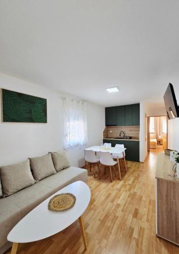 a living room with a couch and a table at Apartmani Marija - Vila Marija in Šilo